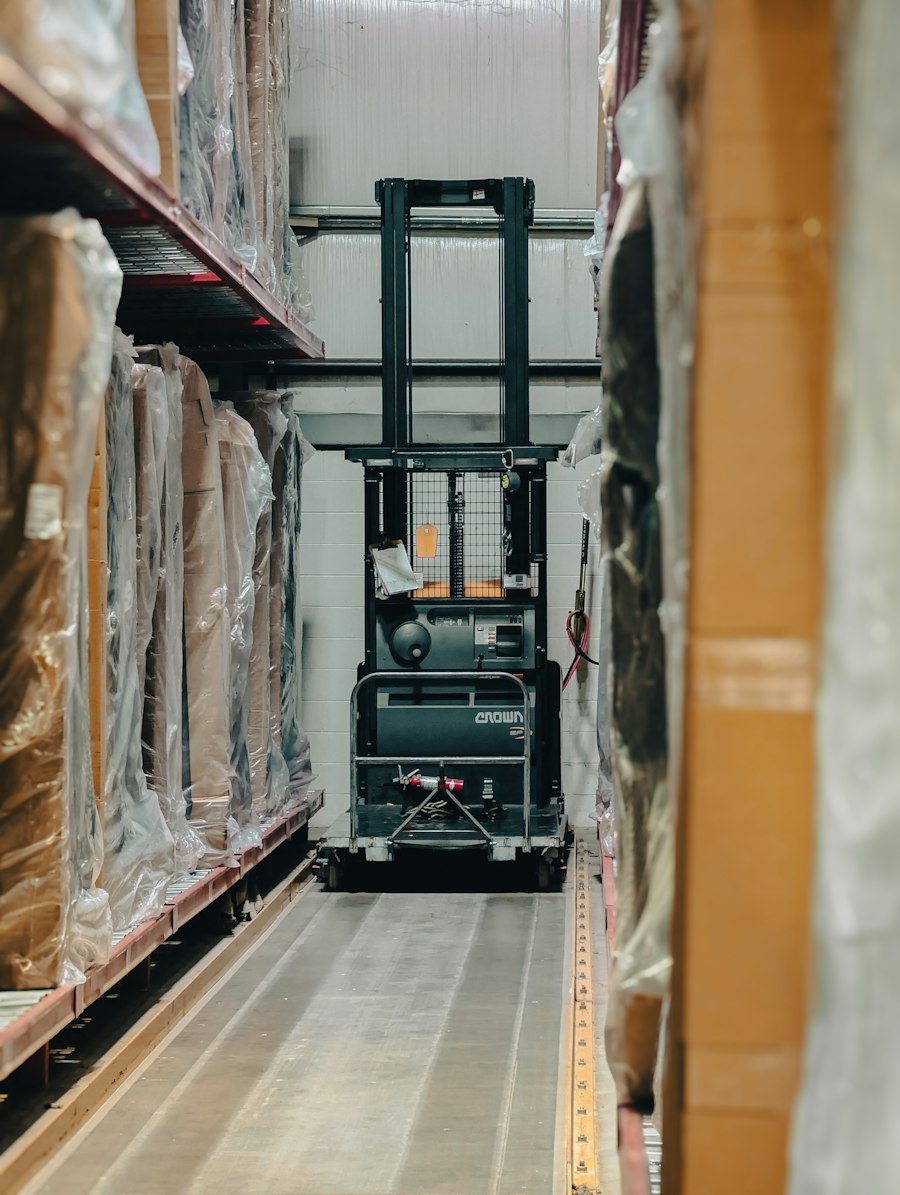 Warehouse aisle with stocked shelves and a forklift